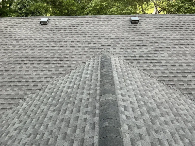 Close-up of new gray architectural shingles along a roof ridge